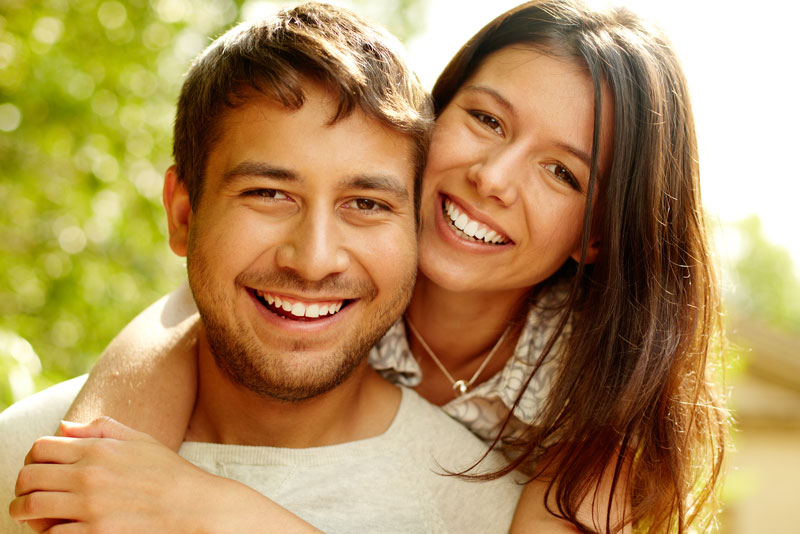 Dental Patients Smiling With Well Cared For Dental Implants In Miami, FL