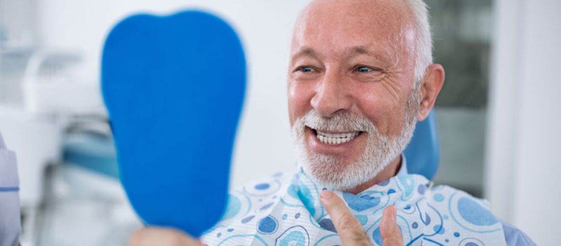 a dental patient smiling after successful dental implant surgery without anxiety