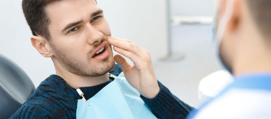 Dental Patient Suffering From Mouth Pain On A Dental Chair, In Miami, FL